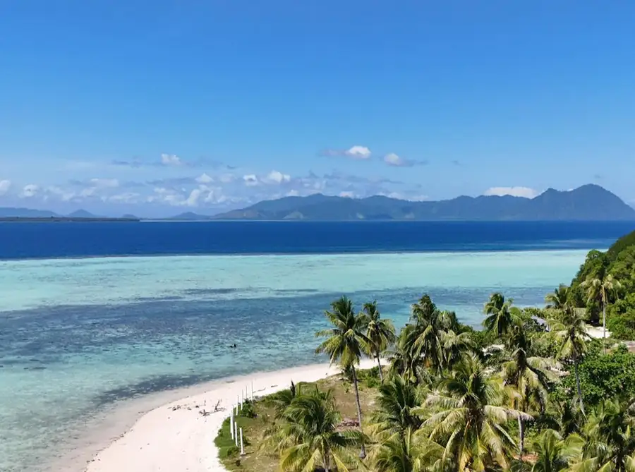Aerial drone view of a beautiful beach island in Semporna Grand Dive Resort