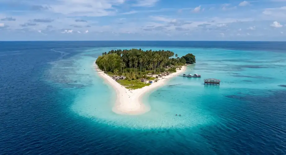 Pristine beach and clear water at Sibuan Island Grand Dive Resort